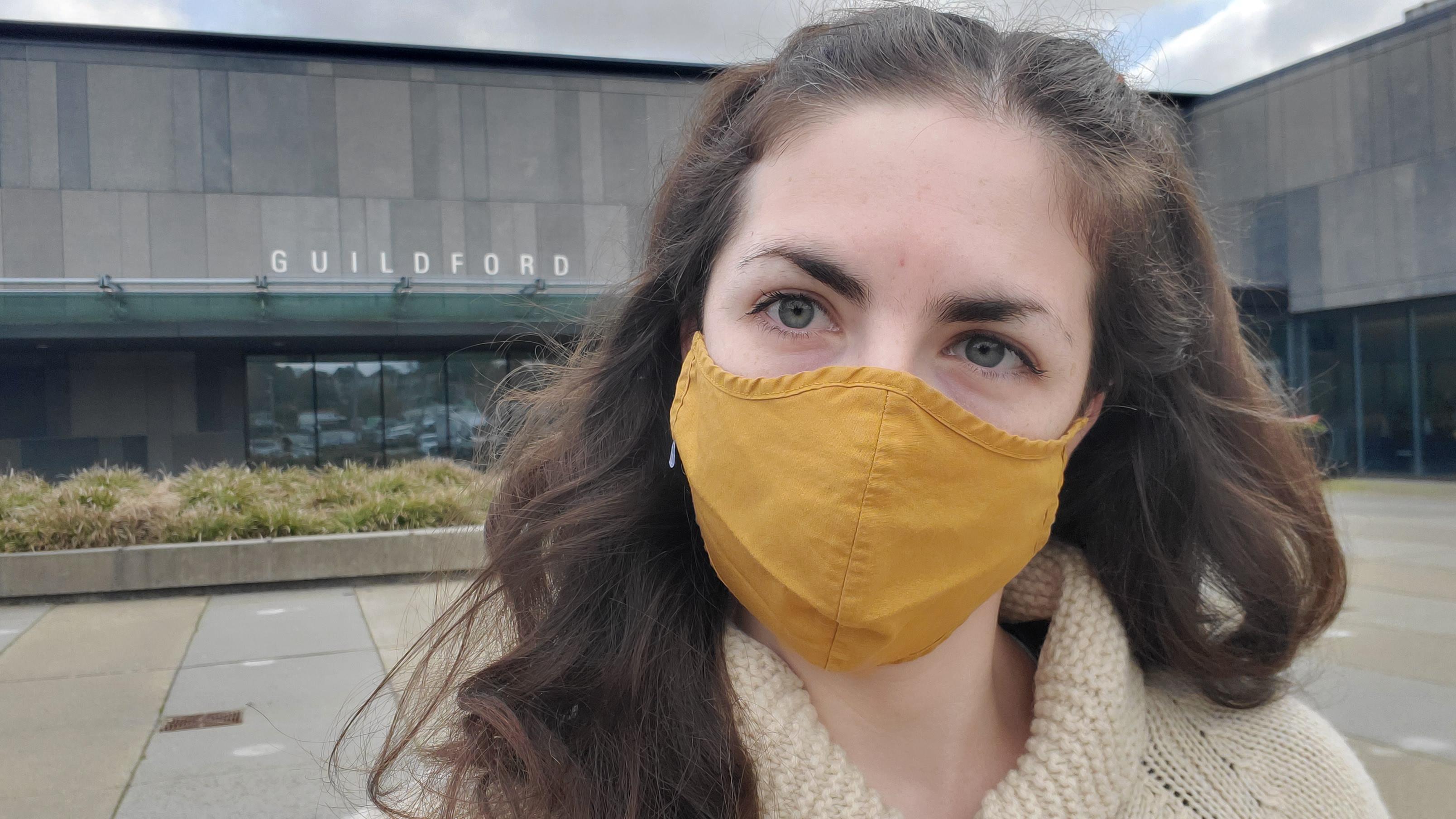 woman wearing a mask in front of a recreation centre